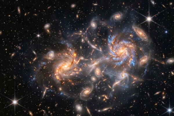 James Webb revela que o ambiente moldava galáxias apenas 1,2 bilhão de anos após o Big Bang. (Imagem: Fala Ciência via Gemini)